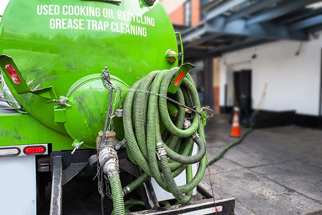 a professional technician pumping a restaurant's grease trap in Belton